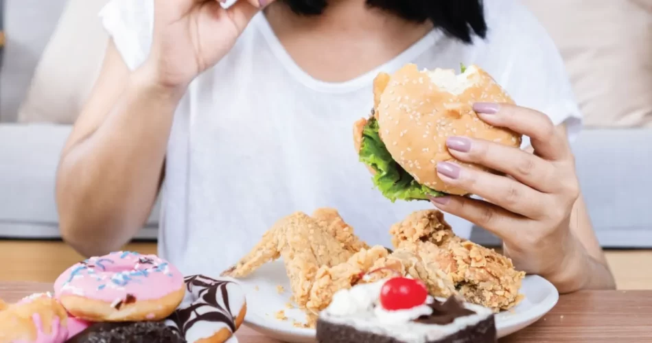 Picture of a woman eating junk food