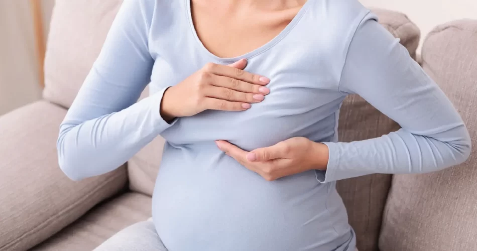 pregnant female testing tender breasts