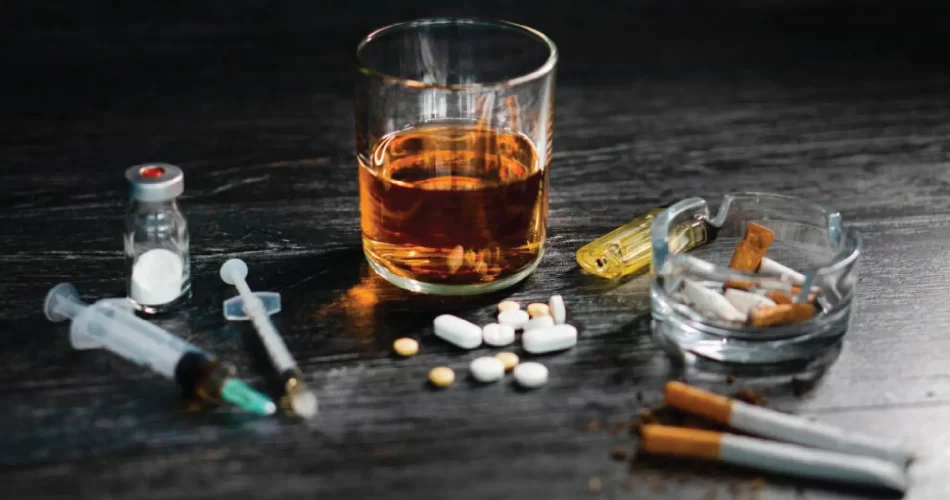Alcohol and other drugs on top of black wooden table